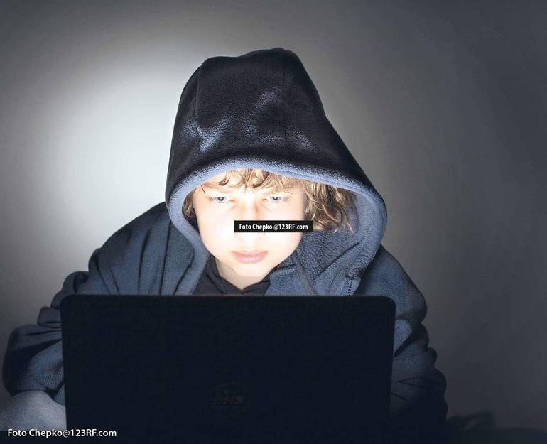 Ragazzo davanti ad un computer in un ambiente buio Ragazzo davanti ad un computer in un ambiente buio
