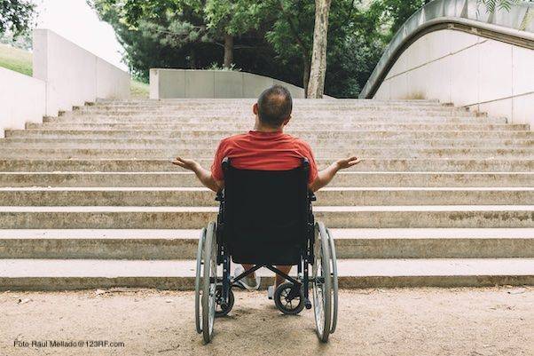 Persona con disabilità in carrozzina difronte ad una scalinata (Foto Raul Mellado@123RF.com)